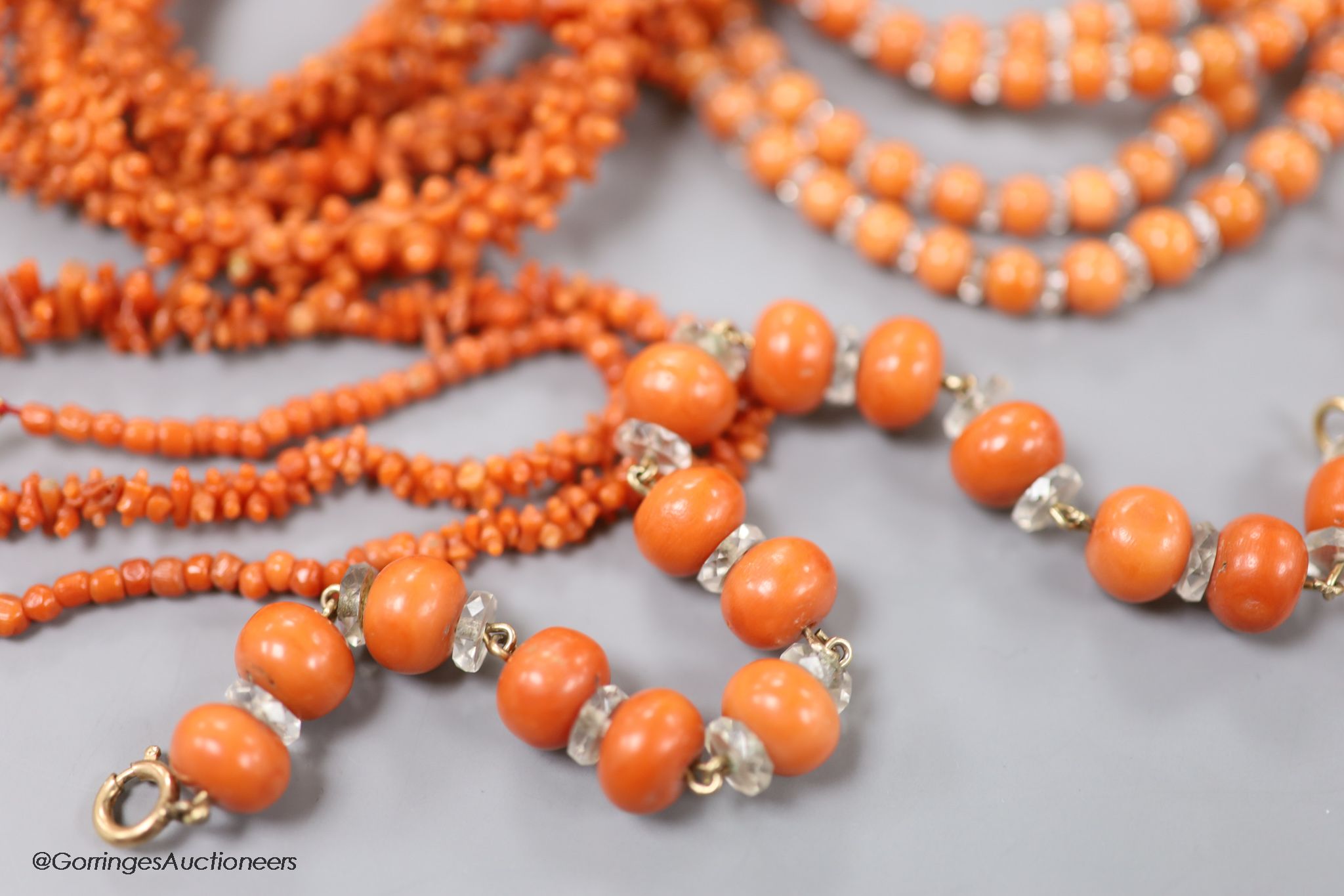 Four assorted coral bead necklaces, largest 148cm and a coral bead bracelet.